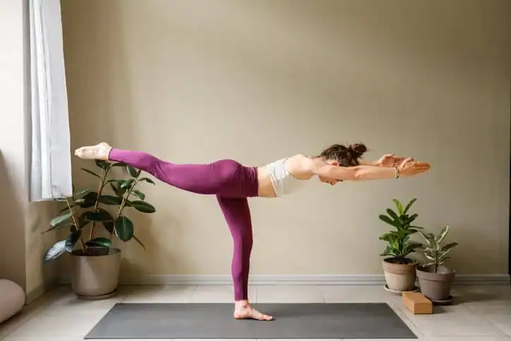 Woman doing Yoga exercise England to help with toning the body. 