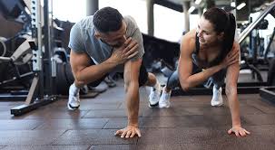 Image of man and woman doing Cardio England to tone their arms. 